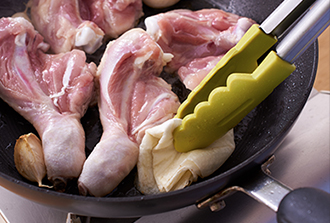 フライパンにオリーブ油を中火で熱し、鶏肉の皮を下にして並べる。にんにくも皮つきのまま加えて一緒に焼く。8分ほどしたら上下を返し、さらに3分ほど焼く。途中脂が出てきたらペーパータオルで吸い取る。