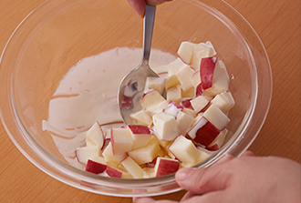 ボウルにAの材料を混ぜておく。りんごは洗って皮つきのまま1.5センチ角に切ってボウルに入れ、手早くあえる。（時間がたつと変色するので注意）。