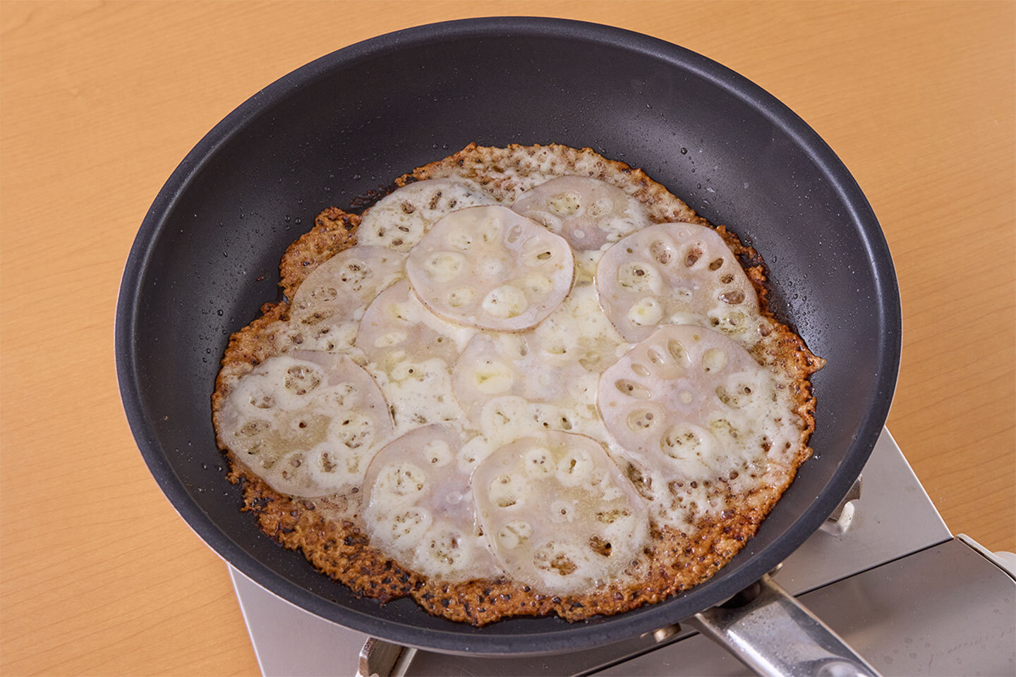 底に敷いたチーズがこんがりと色づき、カリカリになるまでまでゆっくりと焼く。焦がしすぎないよう注意して。焼いた後、ざるにのせて冷ますと、蒸れずにカリッと感がキープできます。