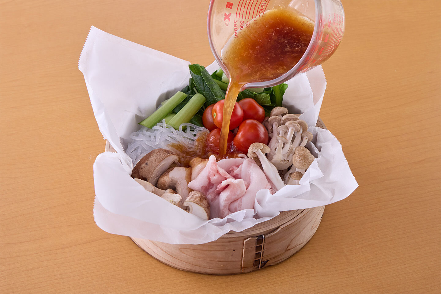 春雨、しめじ、しいたけ、小松菜、ミニトマト、豚肉を入れる。Aを混ぜて注ぎ入れる。